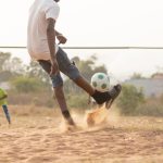 close-up-boy-running-after-ball
